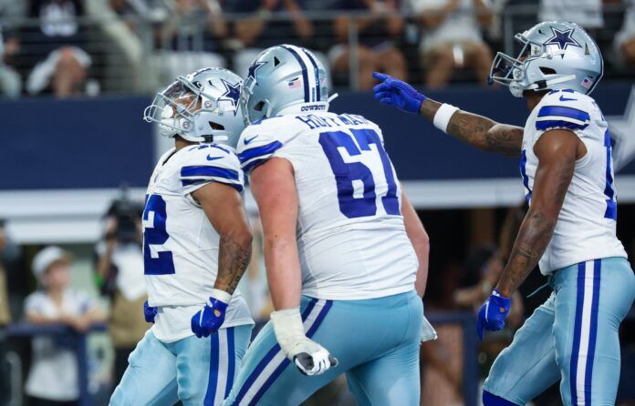 Dallas Cowboys players celebrate RB Deuce Vaughn's (42) touchdown.