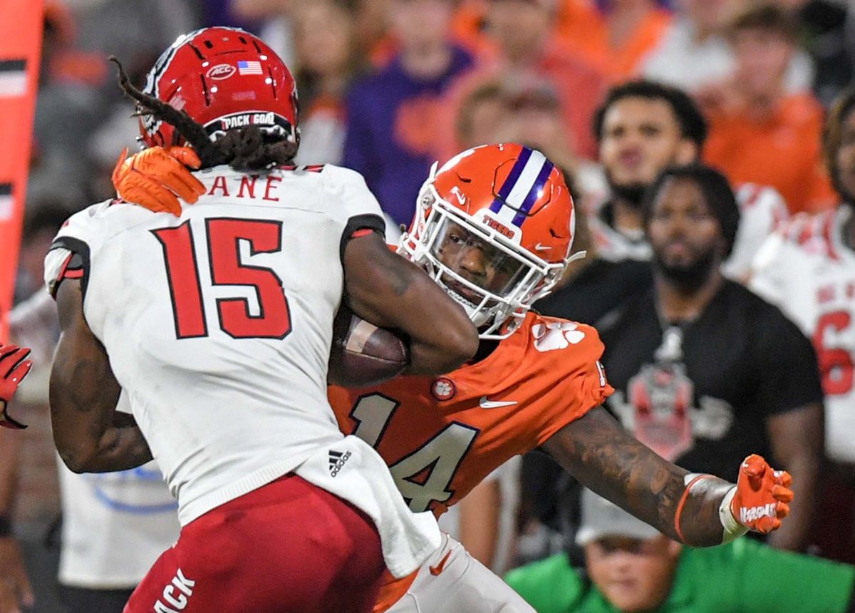 Kevin Swint (14) tackles NC State receiver Keyon Lesane (15) during the first quarter at Memorial Stadium.