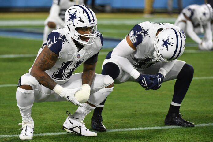 Micah Parsons (11) and Dallas Cowboys linebacker Anthony Barr (42) stretch before the game against the Tennessee Titans at Nissan Stadium.