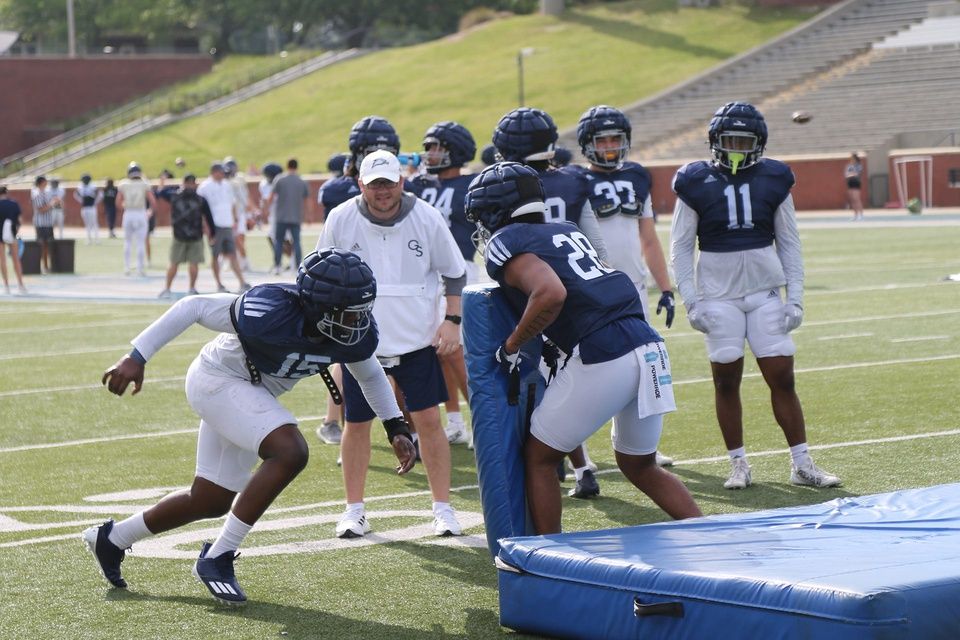 Davon Gilmore prepares to tackle Zyere Horton as defensive coordinator Brandon Bailey looks on during practice at Paulson Stadium.