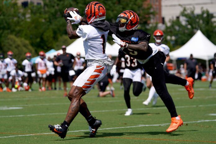 Cam Taylor-Britt (29) breaks up a pass intended for Cincinnati Bengals wide receiver Ja'Marr Chase (1) during NFL training camp practice.