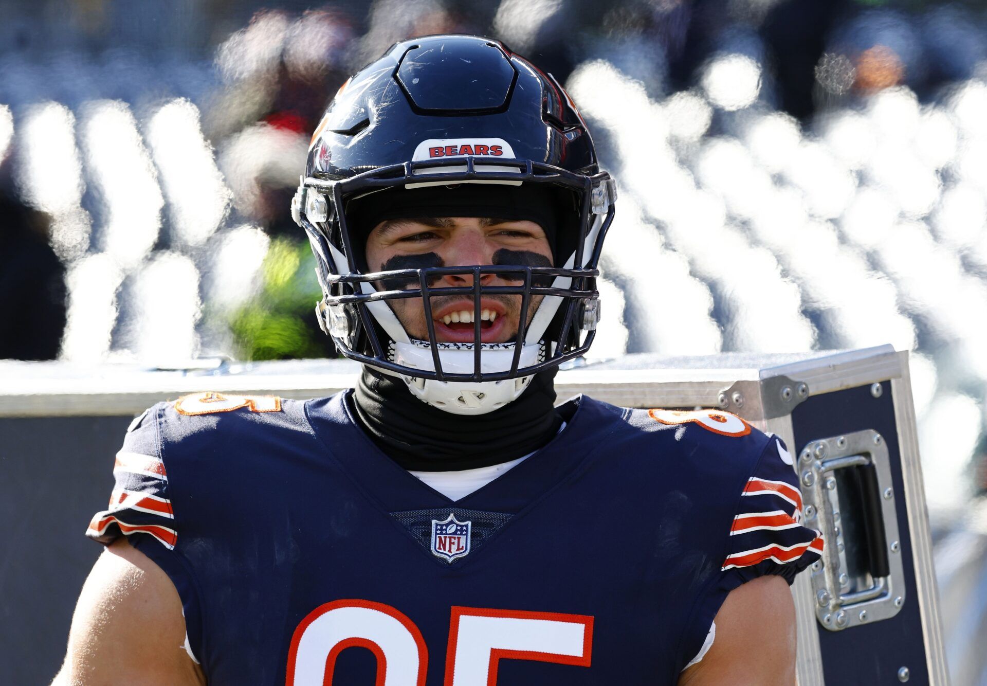 Cole Kmet (85) stands by the heaters along the sideline before the game against the Buffalo Bills at Soldier Field.