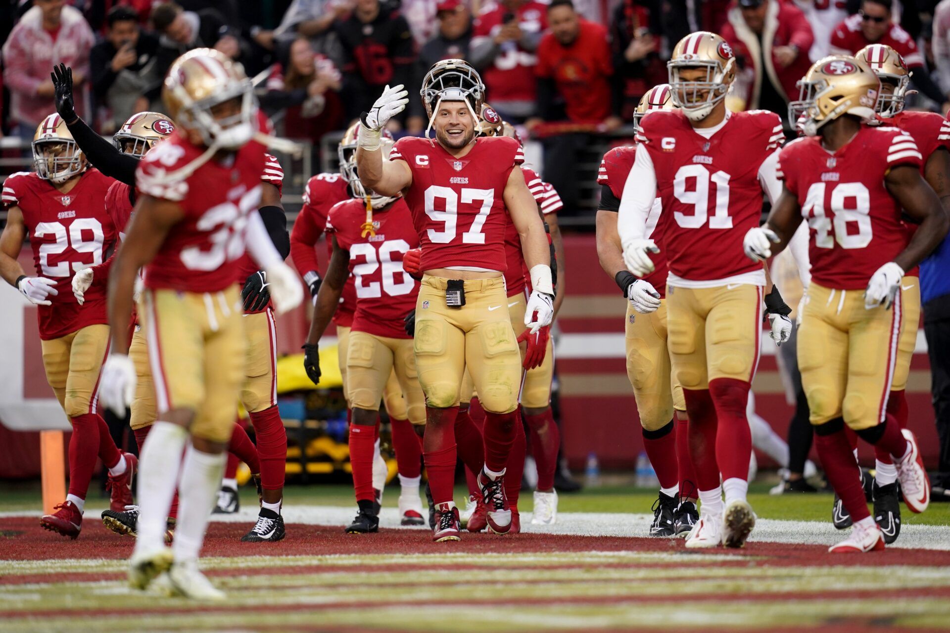 San Francisco 49ers defensive end Nick Bosa (97) gestures toward cornerback Deommodore Lenoir (38) after his interception in the fourth quarter of a wild card game against the Seattle Seahawks at Levi's Stadium.