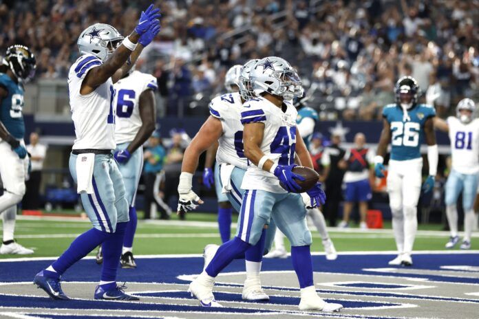 Dallas Cowboys running back Deuce Vaughn (42) scores a touchdown against the Jacksonville Jaguars in the fourth quarter at AT&T Stadium.