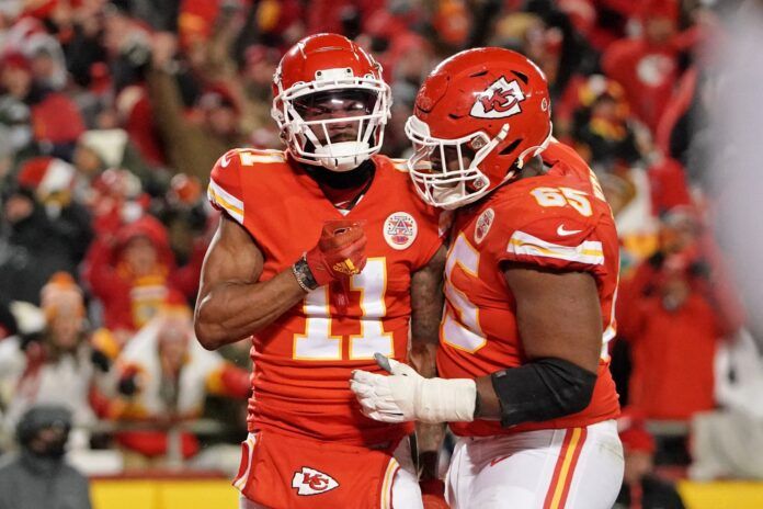 Marquez Valdes-Scantling (11) is congratulated by guard Trey Smith (65) after scoring a touchdown during the third quarter of the AFC Championship game at GEHA Field at Arrowhead Stadium.