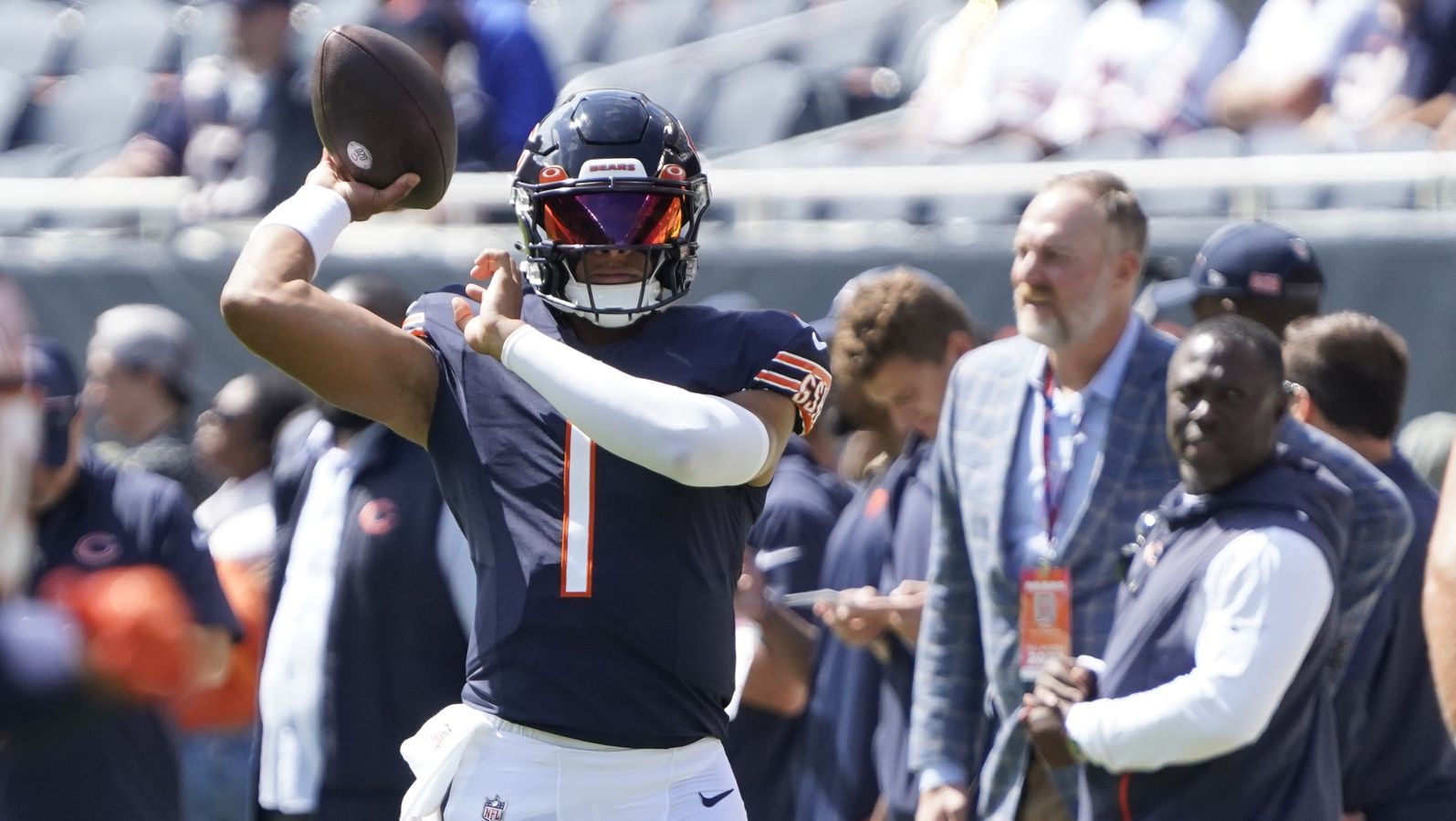 Justin Fields (1) warms up before the game against the Tennessee Titans at Soldier Field.