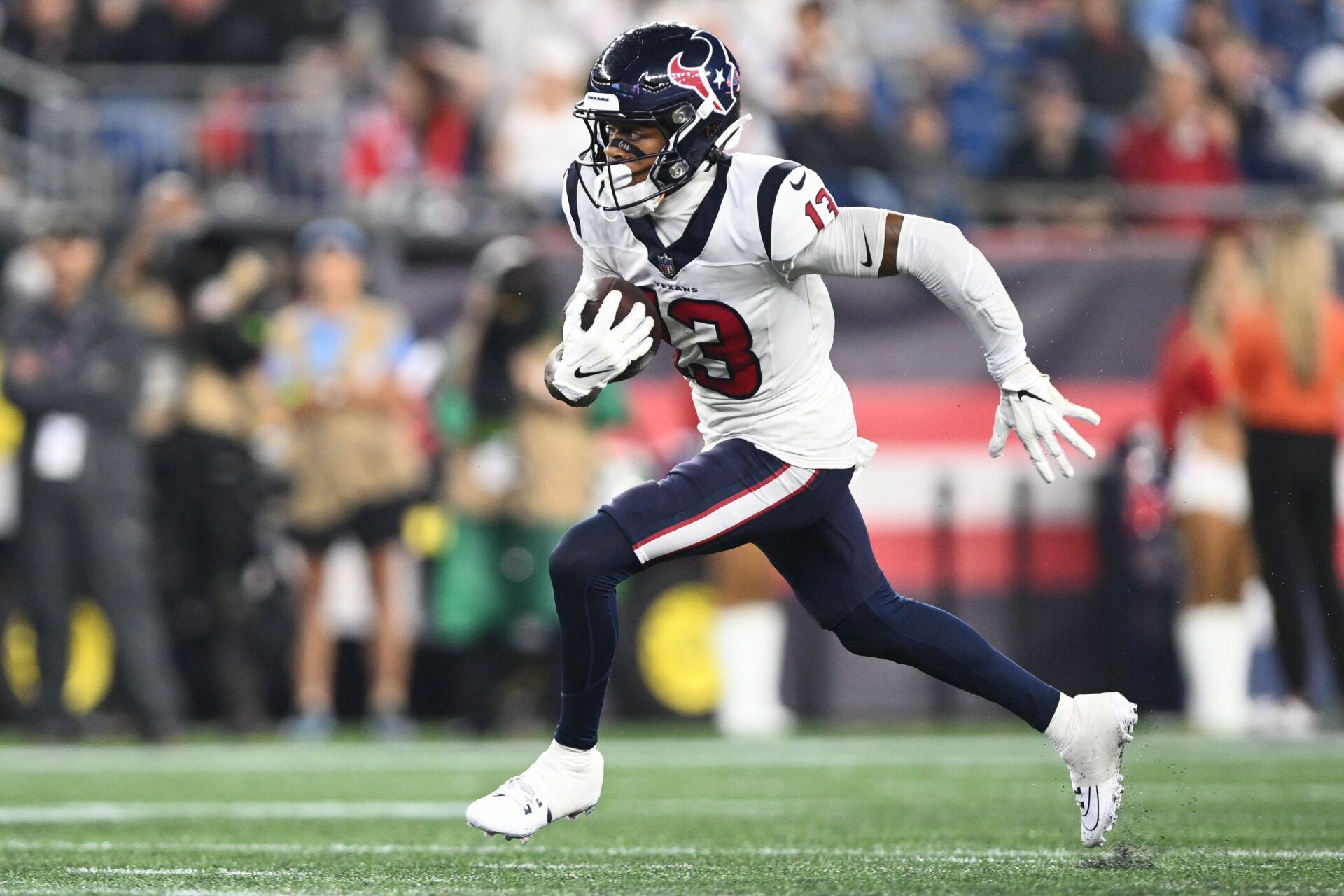 Tank Dell (13) runs with the ball against the New England Patriots during the first half at Gillette Stadium.