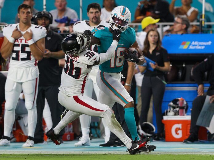 Miami Dolphins wide receiver Erik Ezukanma (18) stiff arms Atlanta Falcons defensive back Breon Borders (36) in the second quarter at Hard Rock Stadium.