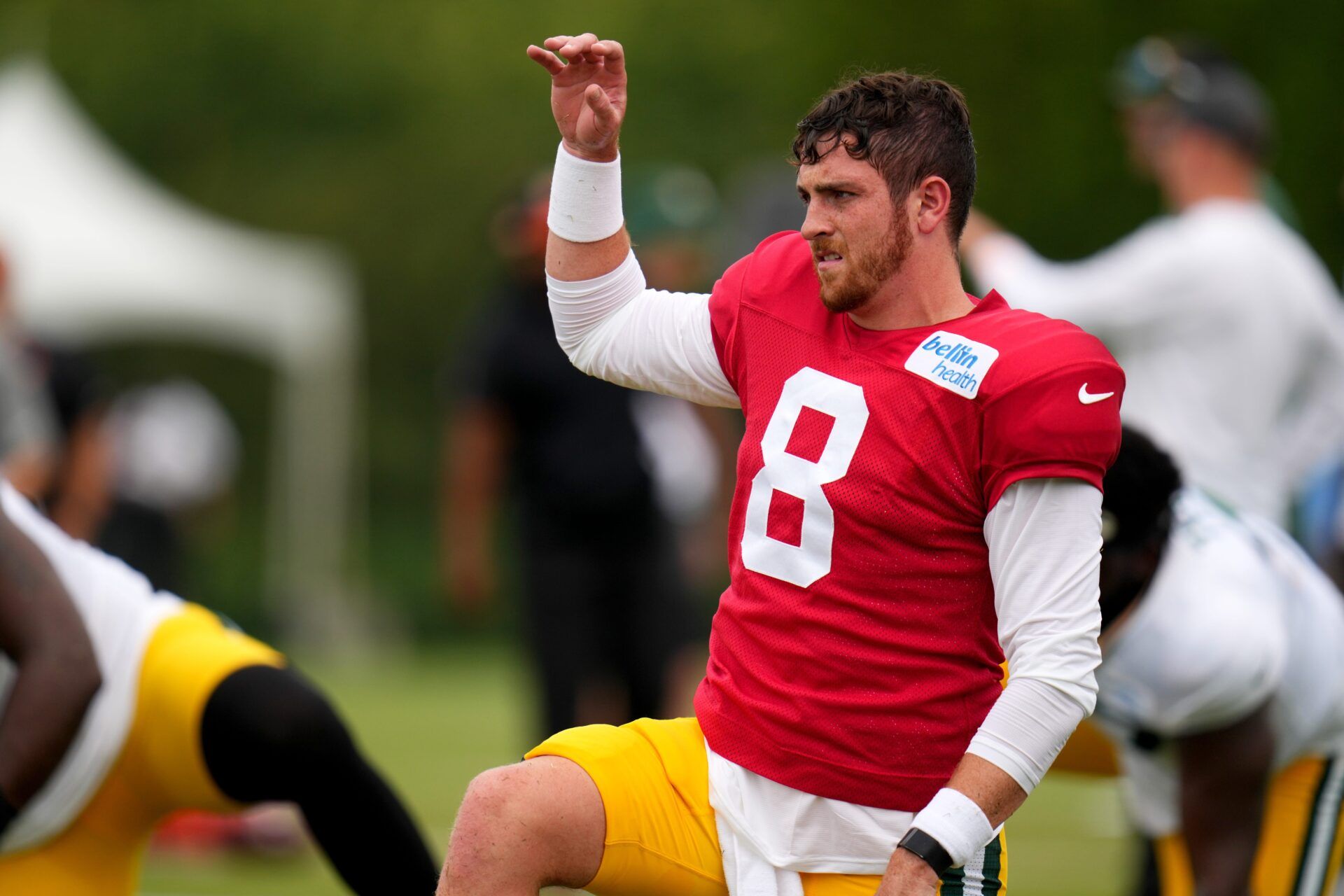 Green Bay Packers QB Sean Clifford (8) stretches before practice.