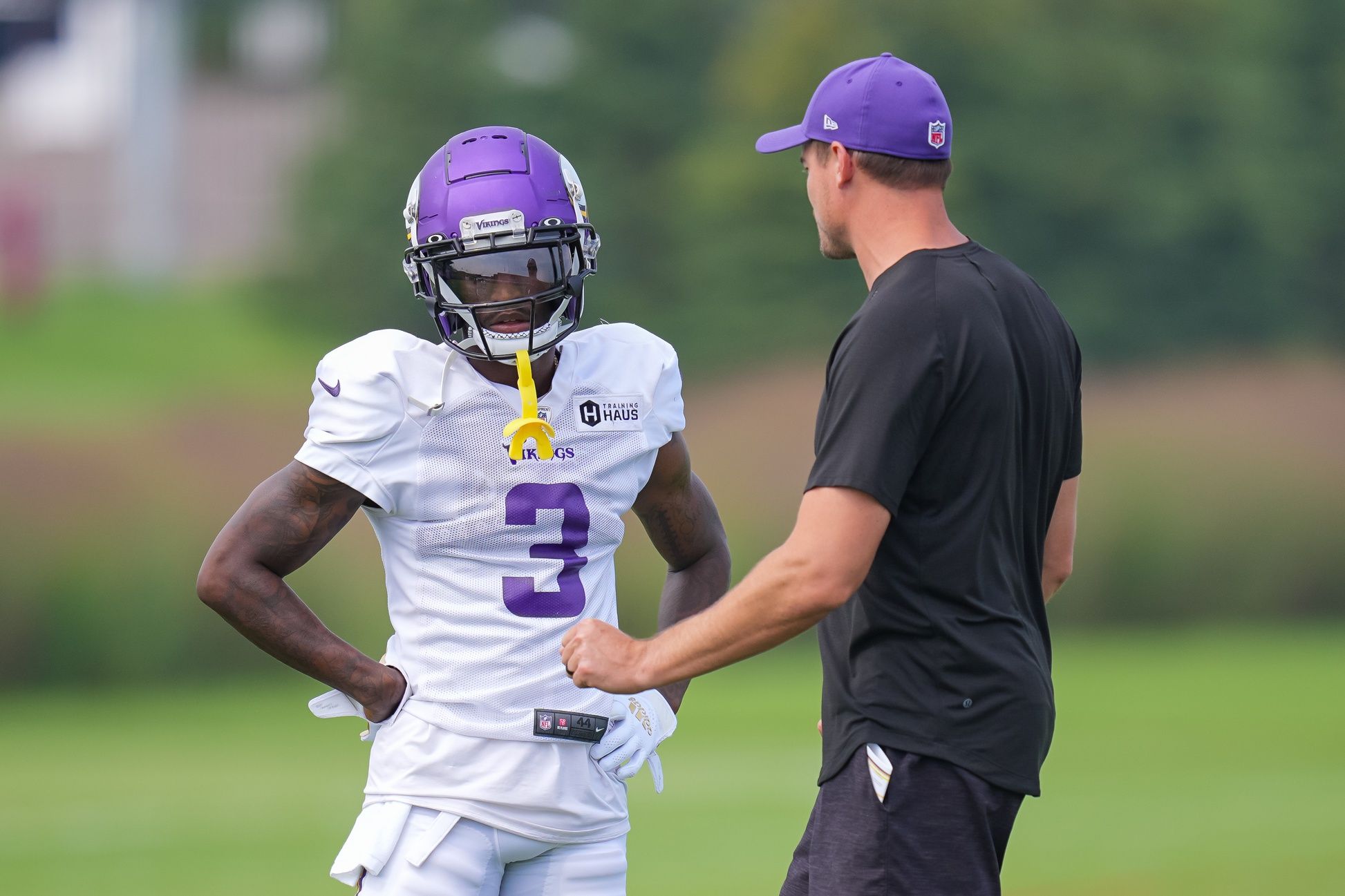 Kevin O'Connell takes to wide receiver Jordan Addison (3) during training camp at Twin Cities Orthopedic Center.