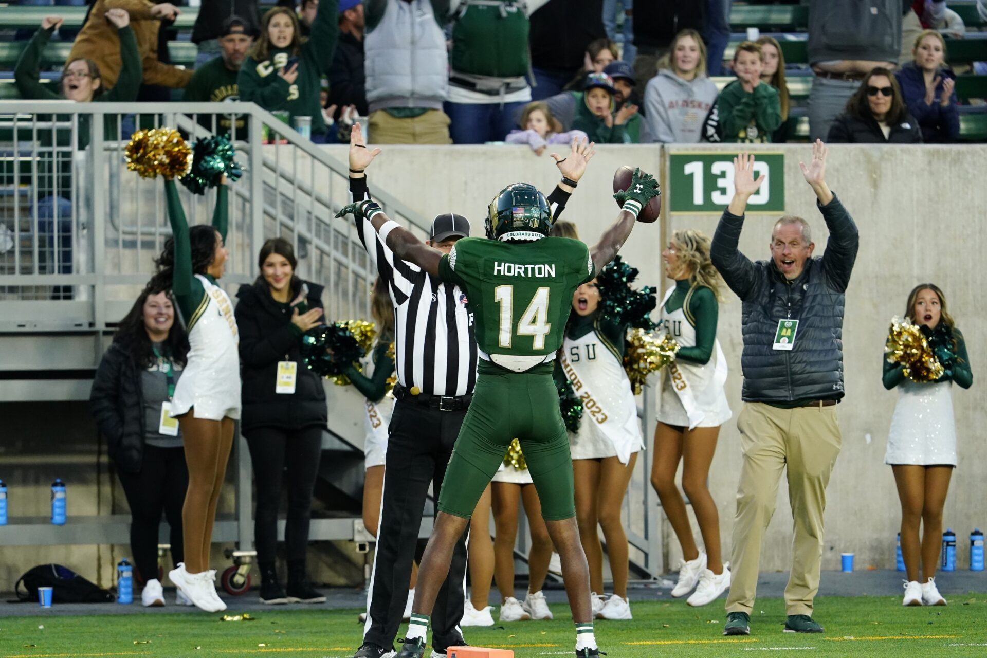 Tory Horton (14) celebrates the final touchdown in the fourth quarter with an official at Sonny Lubick Field at Canvas Stadium.