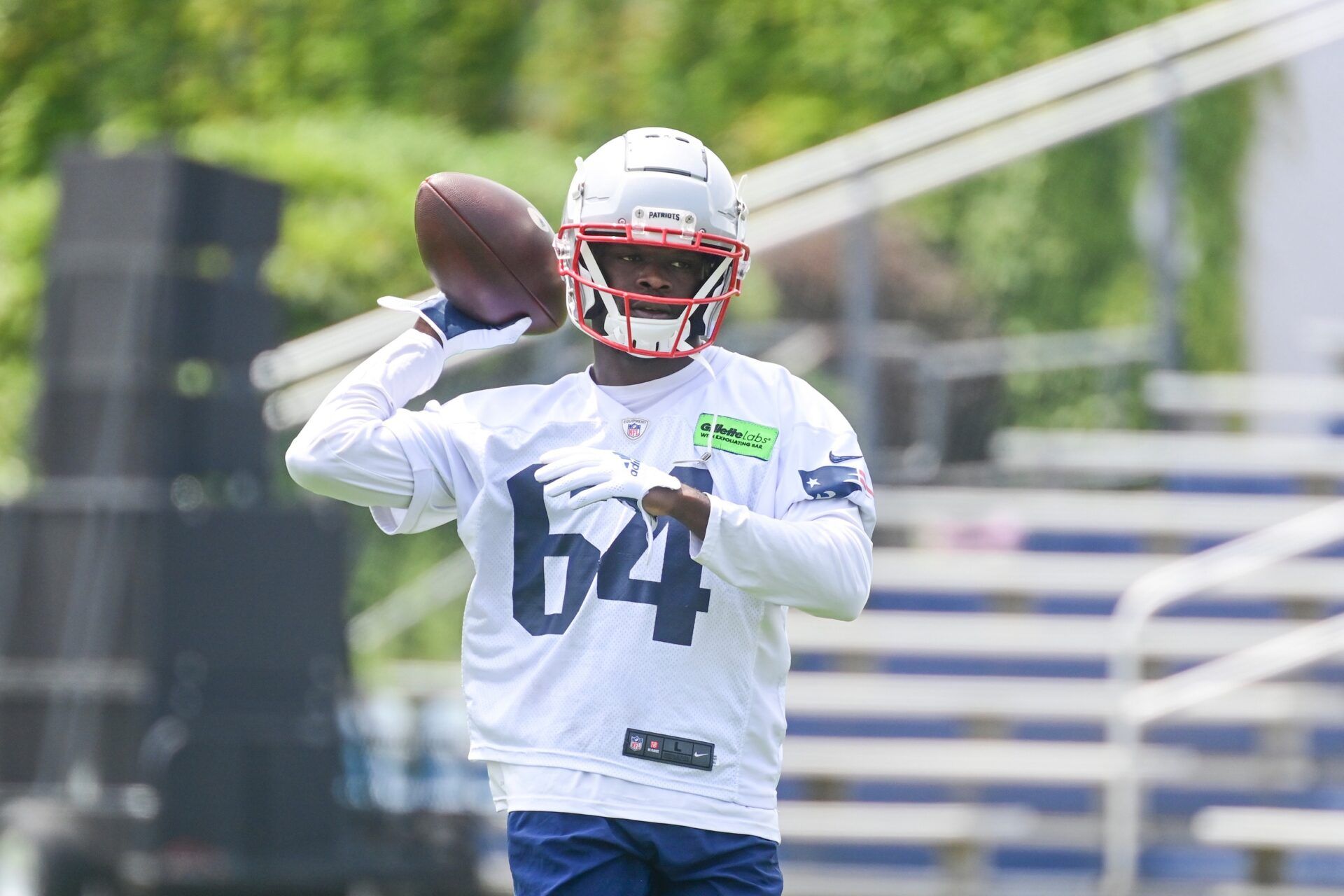 New England Patriots QB Malik Cunningham (64) throws passes at training camp.