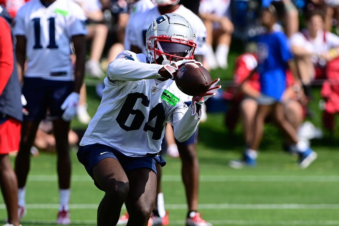 New England Patriots QB Malik Cunningham (64) catches a pass during training camp.