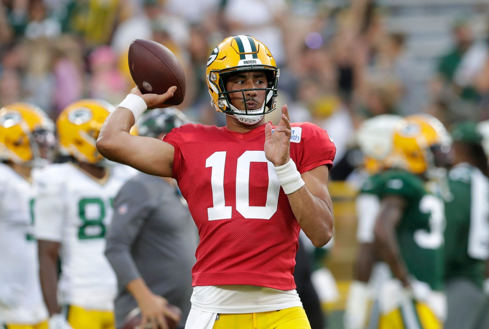 Green Bay Packers QB Jordan Love (10) throws passes during training camp.