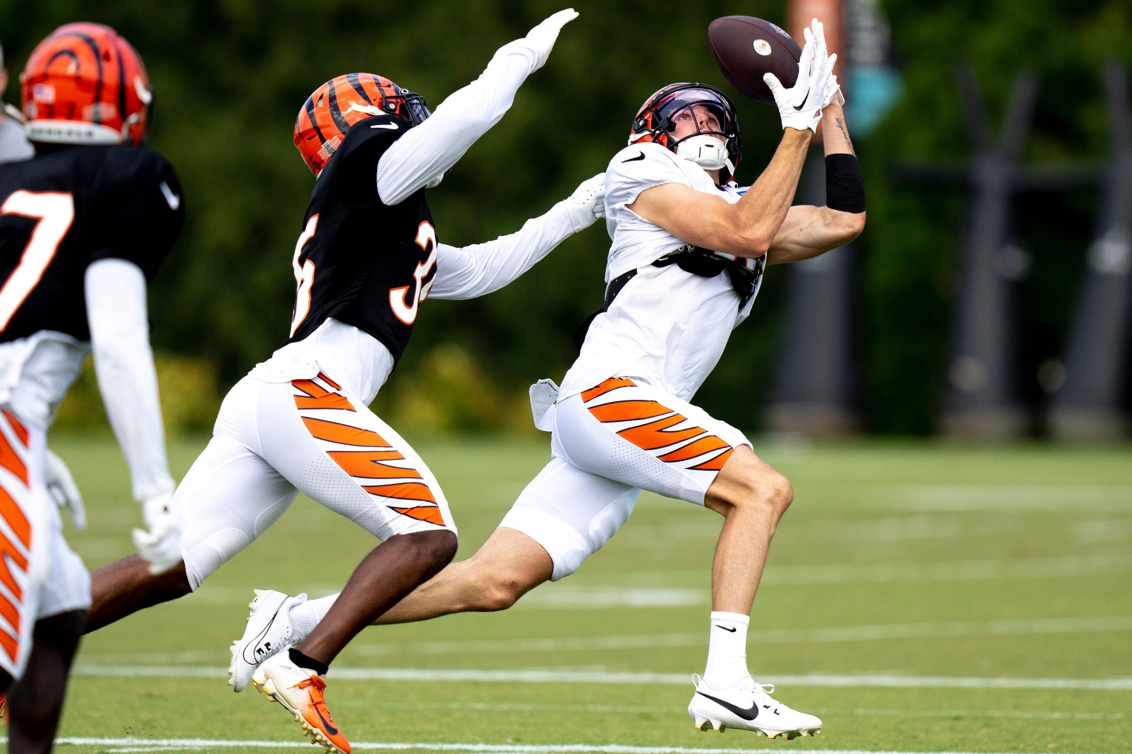 Charlie Jones (15) catches a pass as Cincinnati Bengals cornerback Jalen Davis (35) guards him at the Cincinnati Bengals NFL training camp practice.