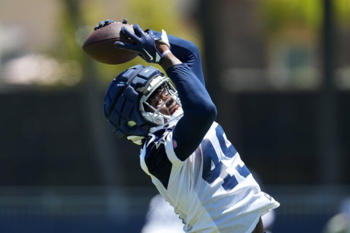 John Stephens (49) wears a Guardian helmet cap during training camp at Marriott Residence Inn-River Ridge Playing Fields.