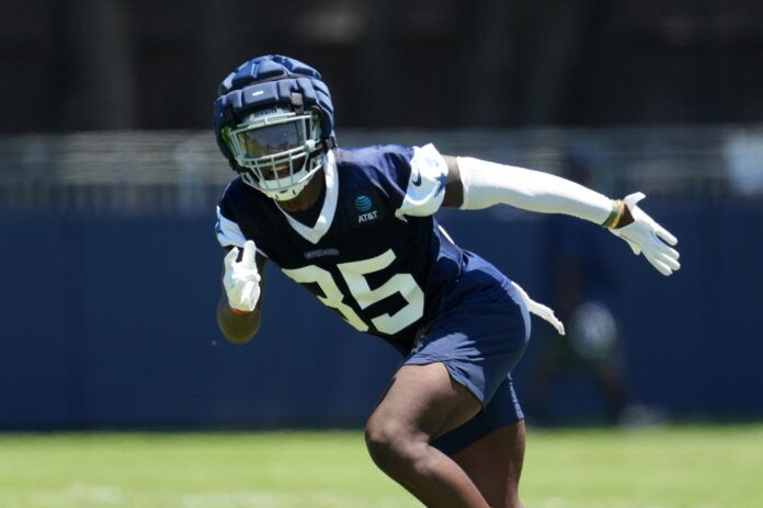 DeMarvion Overshown (35) wears a Guardian helmet cap during training camp at Marriott Residence Inn-River Ridge Playing Fields.