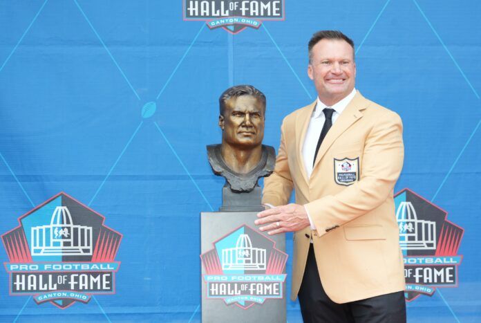 Zach Thomas poses with his bust during the 2023 Pro Football Hall of Fame Enshrinement at Tom Benson Hall of Fame Stadium.