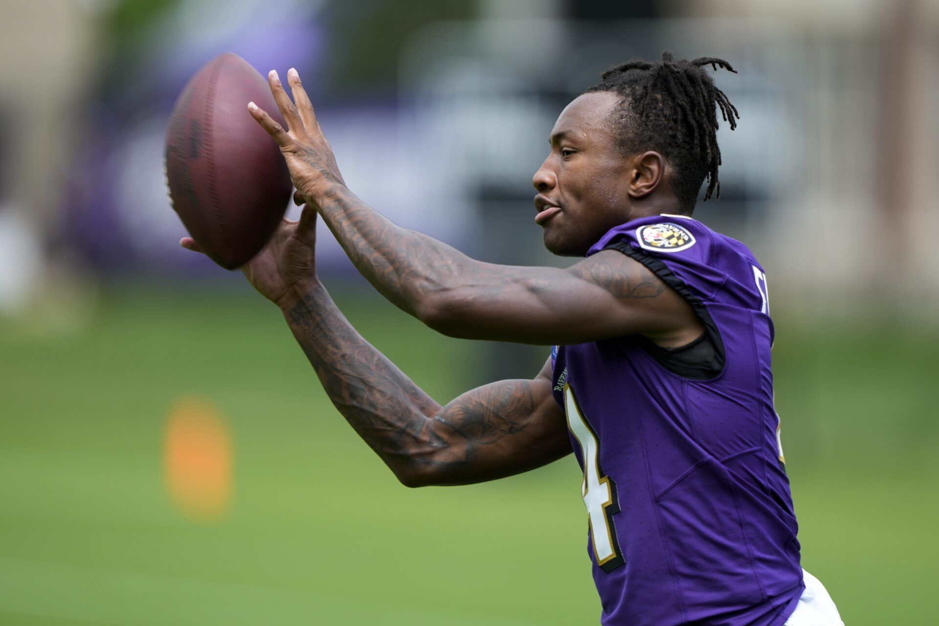 Baltimore Ravens WR Zay Flowers (4) catching passes during training camp.