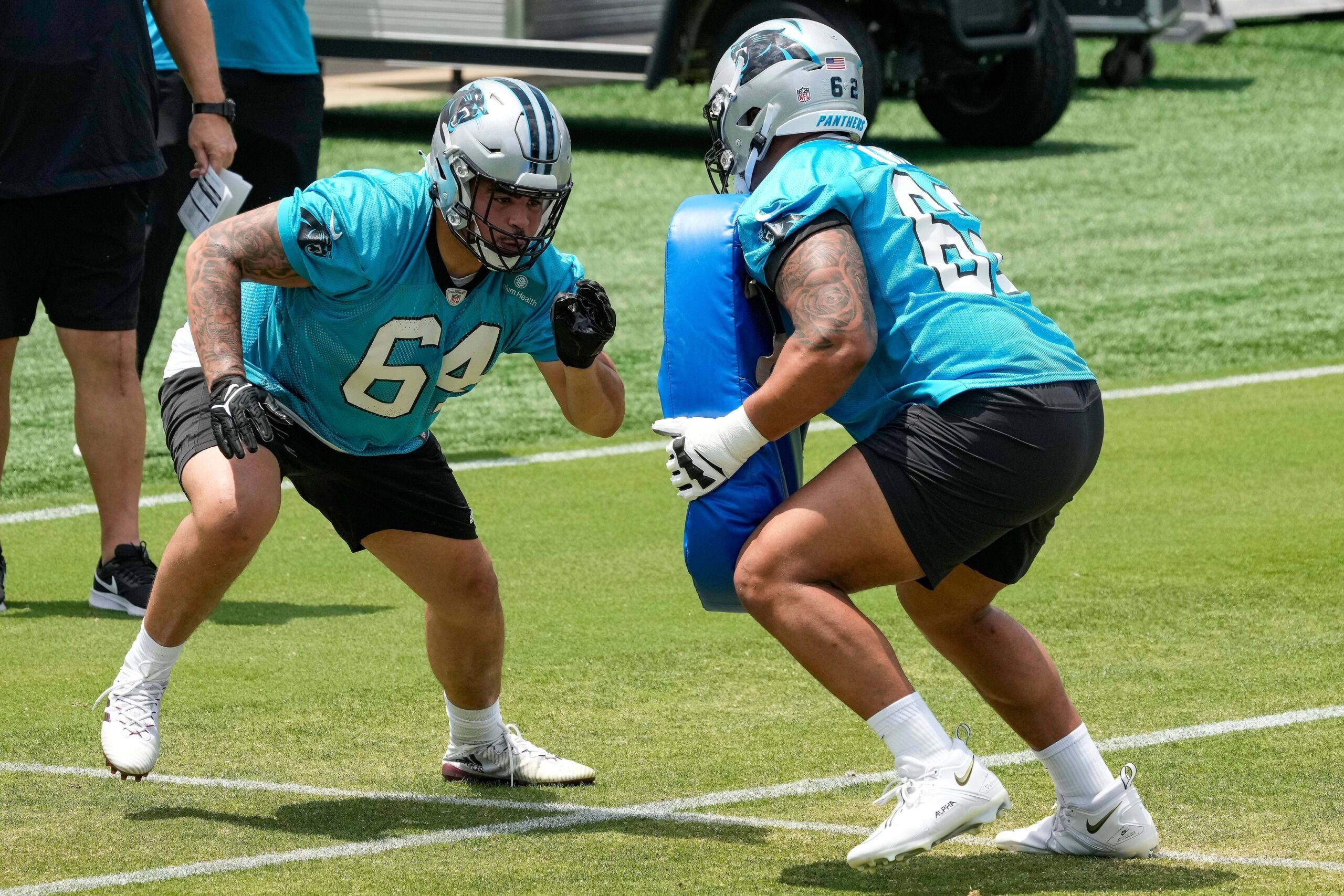 Dohnovan West (64) in a blocking drill against lineman Chandler Zavala (62) during the Carolina Panthers rookie camp at the Atrium Practice Facility in Charlotte, NC.