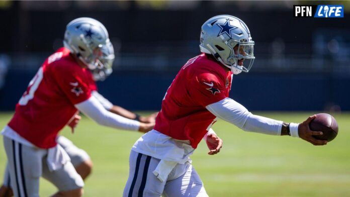 Cowboys QB Dak Prescott at practice handing off the ball.