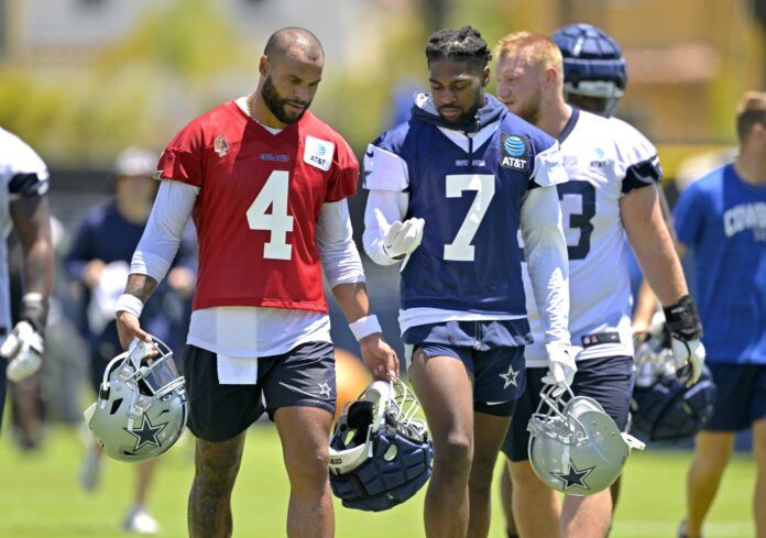 Dallas Cowboys players Dak Prescott (4) and Trevon Diggs (7) talk after practice.