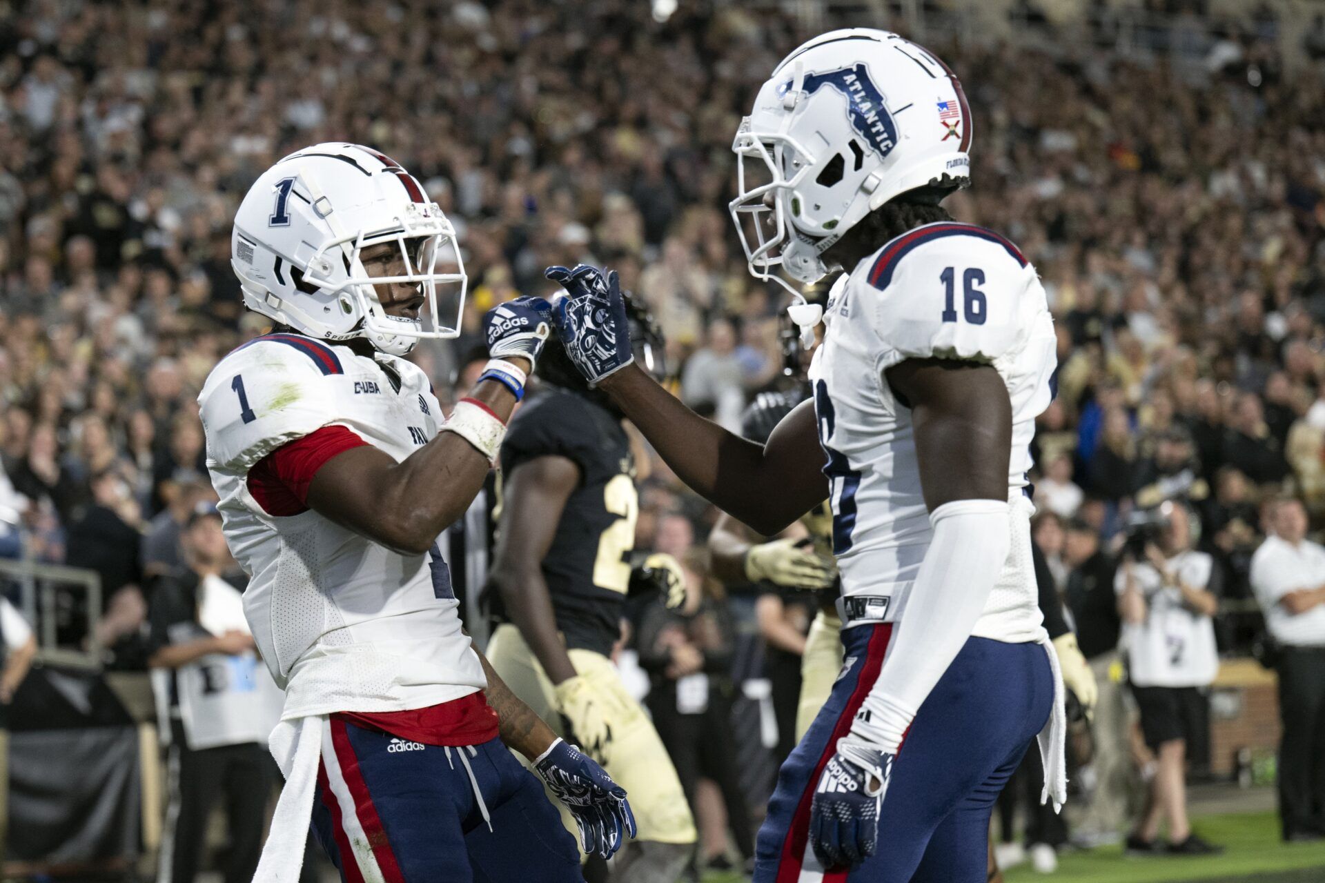 Florida Atlantic Owls wide receivers Tony Johnson (16) and LaJohntay Wester (1) celebrate a touchdown.