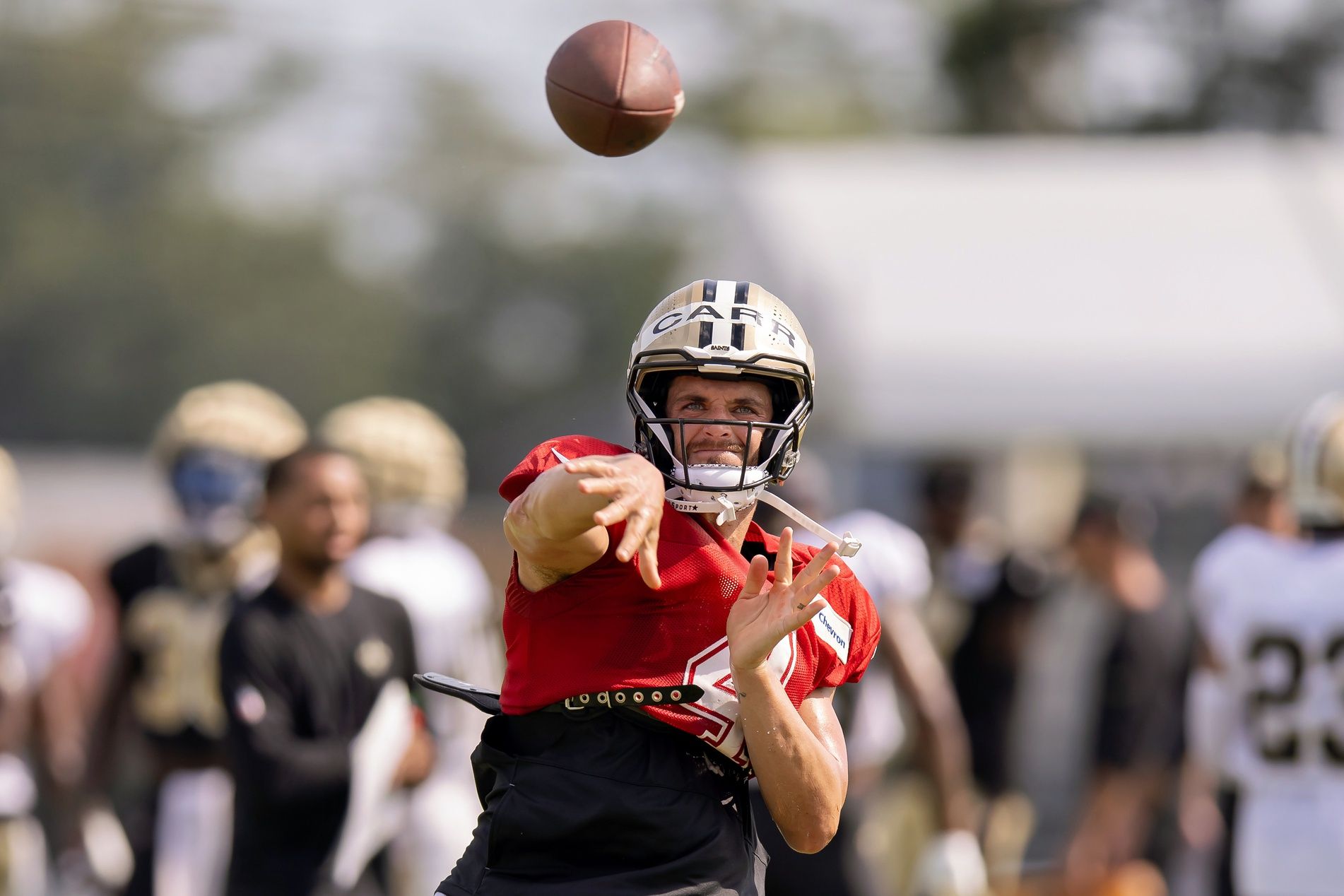 New Orleans Saints QB Derek Carr (4) throws a pass during training camp.