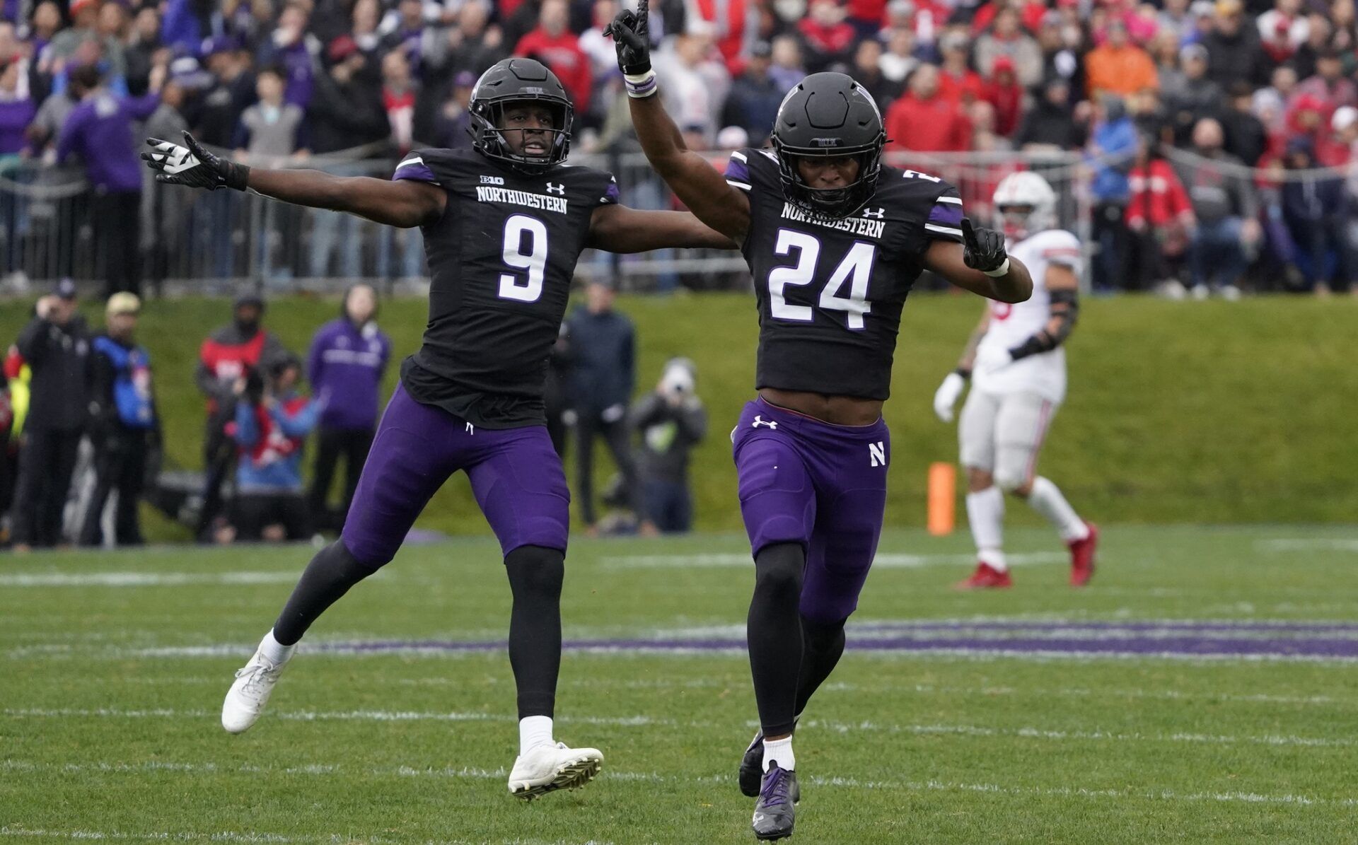 Rod Heard II (24) and defensive back Jeremiah Lewis (9) celebrate a stop against the Ohio State Buckeyes during the first half at Ryan Field.