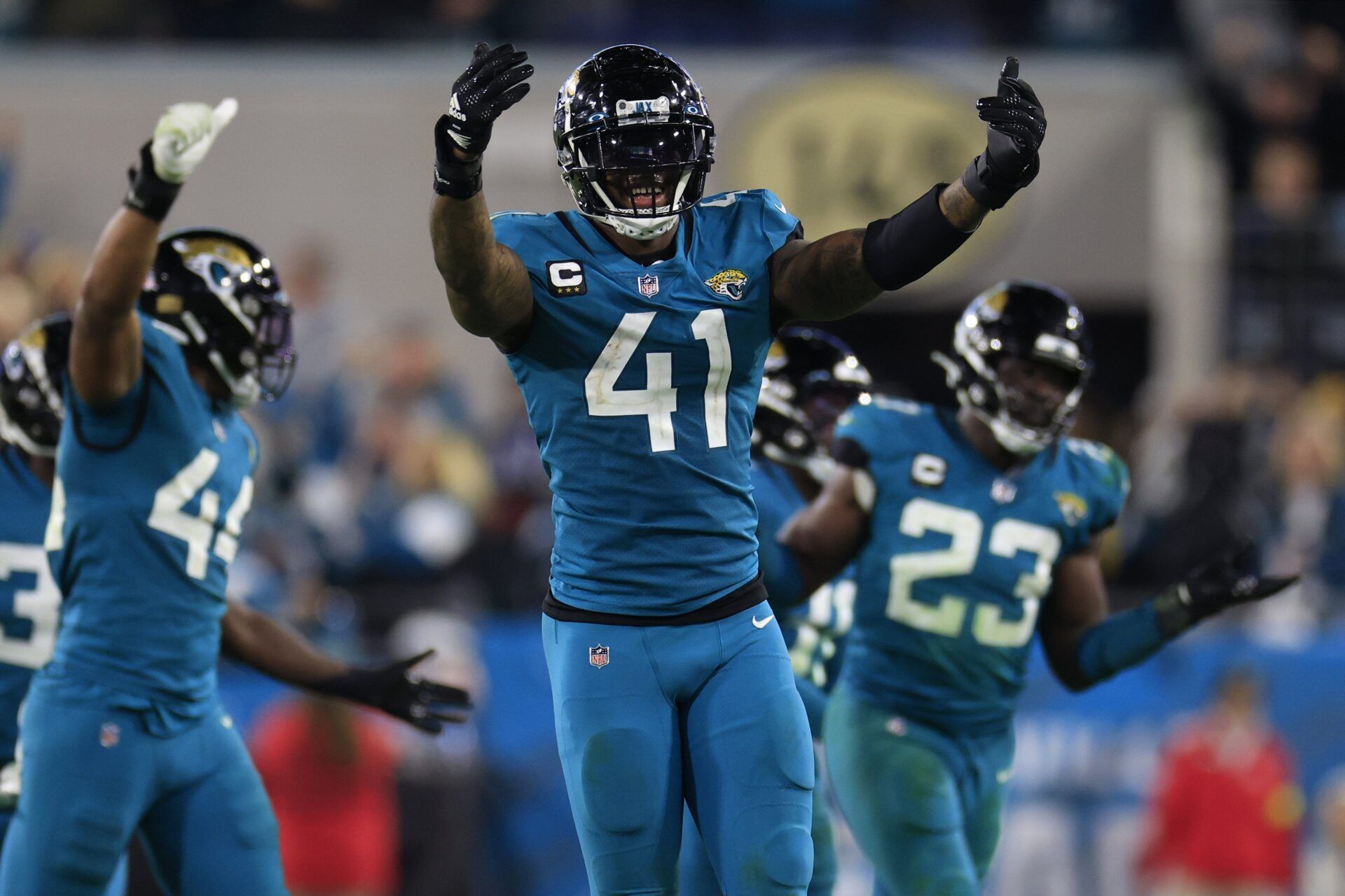 Jacksonville Jaguars DE Josh Allen (41) and teammates celebrate a defensive stop.