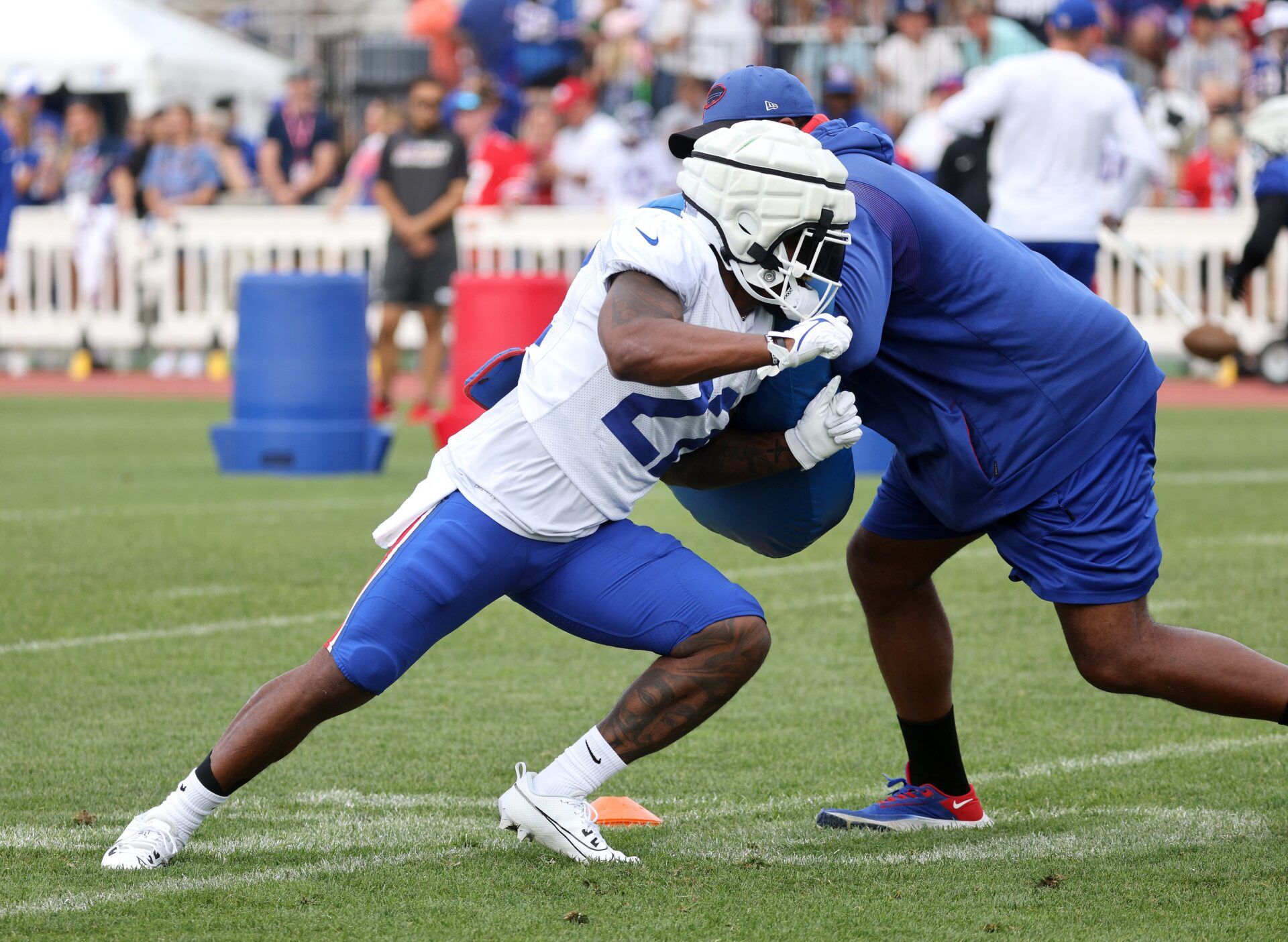 Damien Harris fights off a block during training camp.