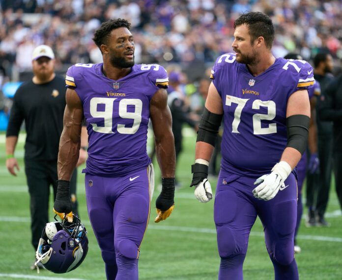 Danielle Hunter (99) and Minnesota Vikings guard Ezra Cleveland (72) during the NFL International Series game at Tottenham Hotspur Stadium.