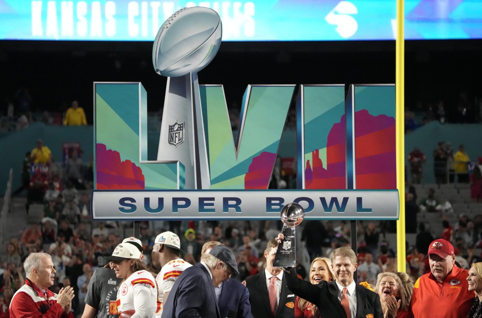 Clark Hunt hoists the Lombardi Trophy after the Chiefs defeated the Philadelphia Eagles in Super Bowl LVII.