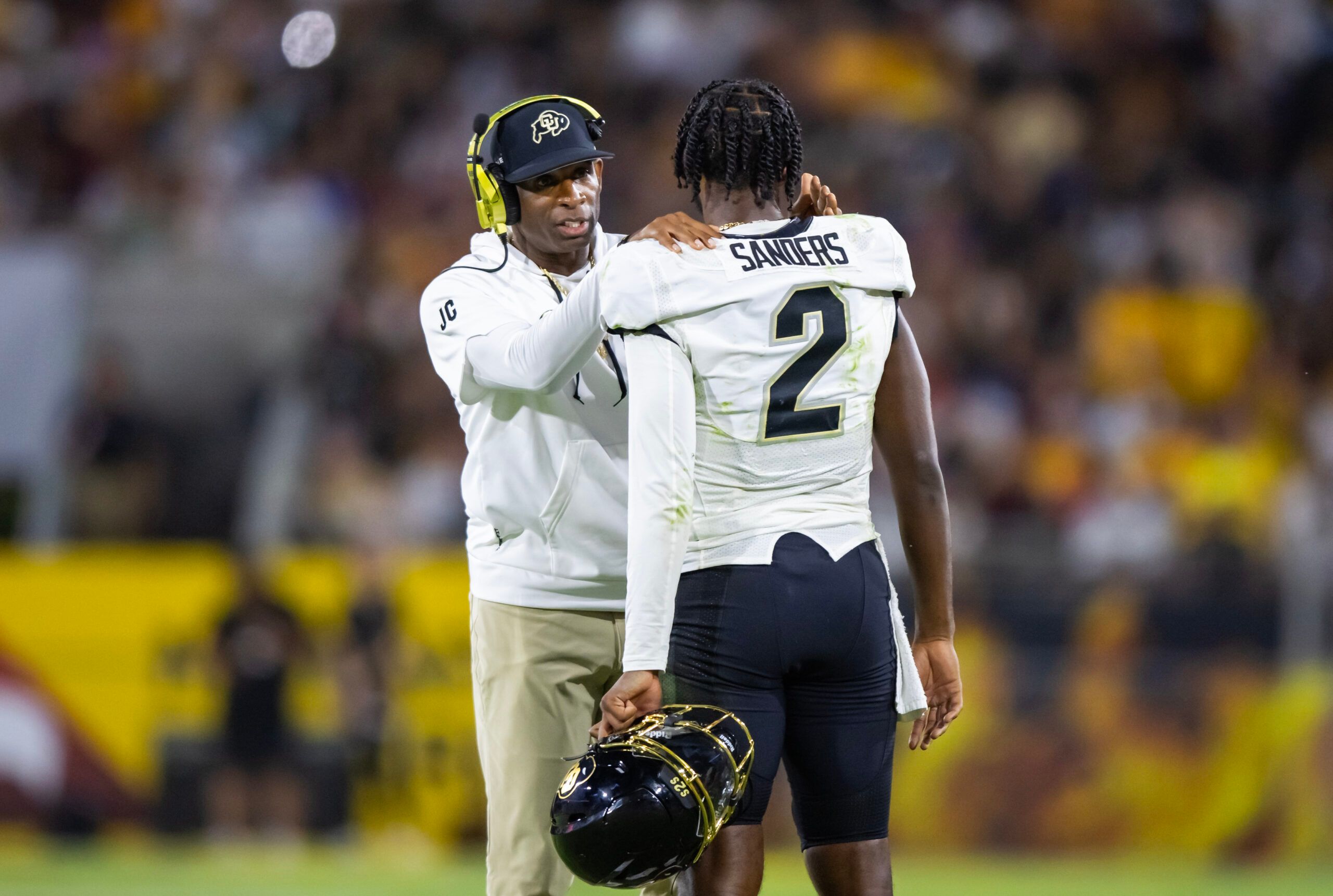 Oct 7, 2023; Tempe, Arizona, USA; Colorado Buffaloes head coach Deion Sanders with son and quarterback Shedeur Sanders (2) against the Arizona State Sun Devils at Mountain America Stadium. 