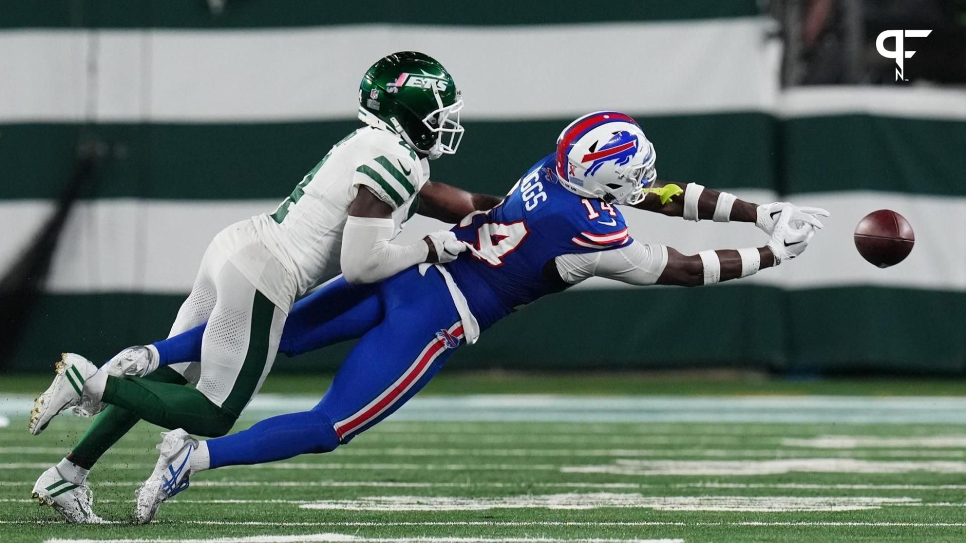 Stefon Diggs (14) cannot complete the pass with pressure from New York Jets cornerback D.J. Reed (4) in the second half.