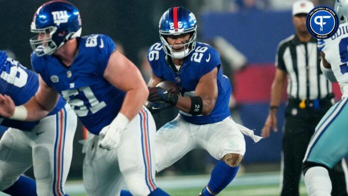 Saquon Barkley (26) tries to find an open hole against the Dallas defense.