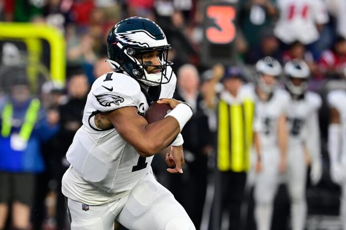 Philadelphia Eagles quarterback Jalen Hurts (1) runs the ball against the New England Patriots during the second half at Gillette Stadium.