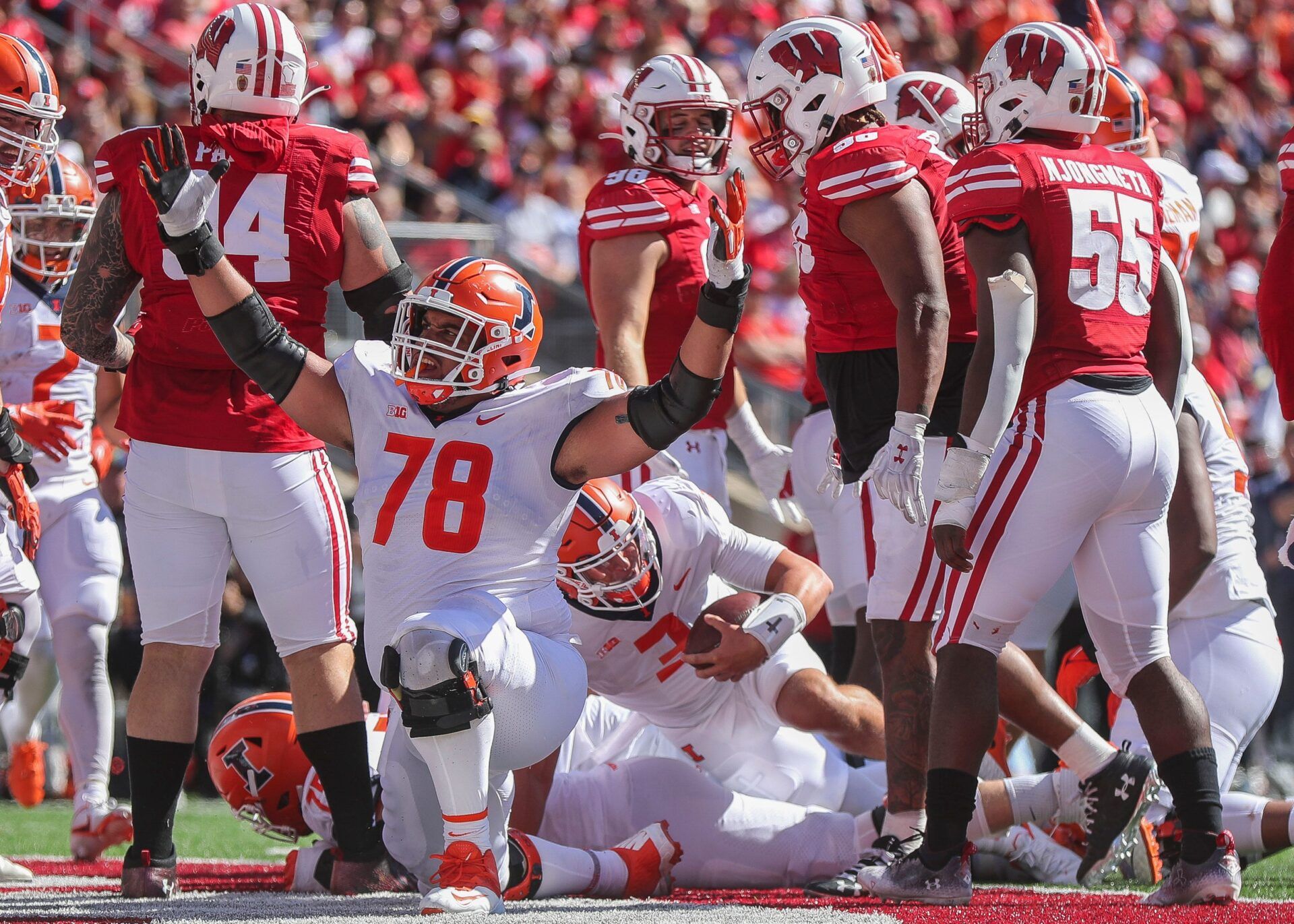 Illinois offensive lineman Isaiah Adams signals for a touchdown after quarterback Tommy DeVito (3) scores a touchdown on Saturday, October 1, 2022, at Camp Randall Stadium in Madison, Wis. Illinois won the game, 34-10, in current Illini and former Badgers head coach Bret Bielema s return to Madison.