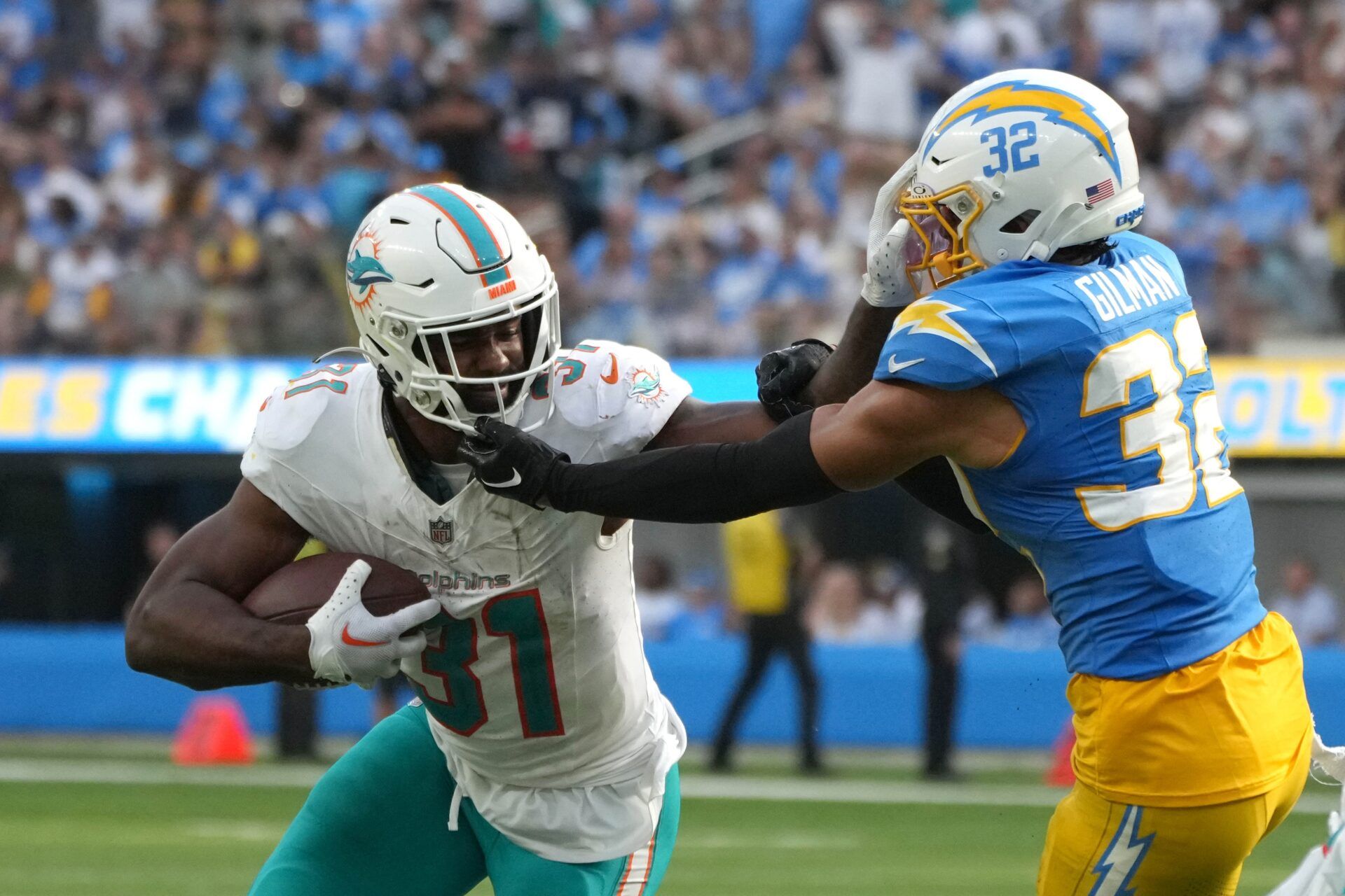 Raheem Mostert (31) carries the ball against Los Angeles Chargers safety Alohi Gilman (32) in the second half at SoFi Stadium.