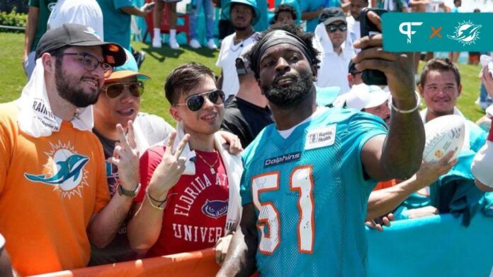 David Long (51) poses for a selfie with fans at training camp at Baptist Health Training Complex.