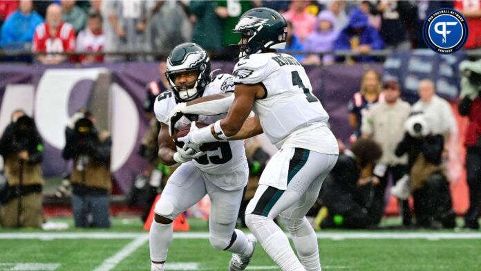 Philadelphia Eagles quarterback Jalen Hurts (1) fakes a handoff to running back Boston Scott (35) during the first half against the New England Patriots at Gillette Stadium.