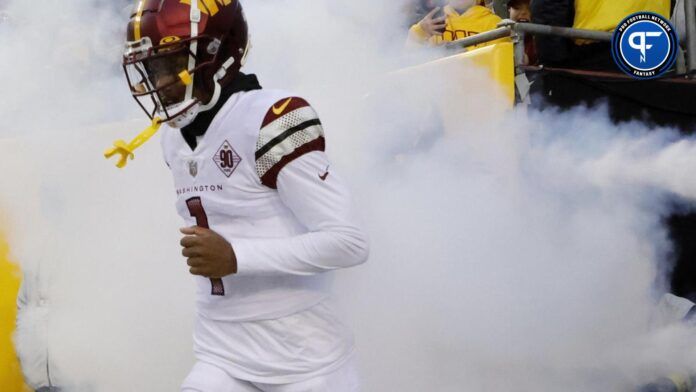 Washington Commanders WR Jahan Dotson comes out of the tunnel with smoke.