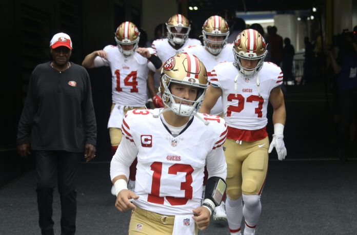 San Francisco 49ers quarterback Brock Purdy (13) and teammates take the field to play the Pittsburgh Steelers at Acrisure Stadium.