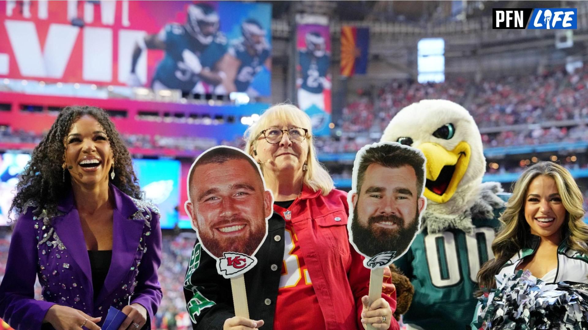 Donna Kelce holds up photos of her sons Kansas City Chiefs tight end Travis Kelce (not pictured) and Philadelphia Eagles center Jason Kelce (not pictured) before Super Bowl LVII at State Farm Stadium.