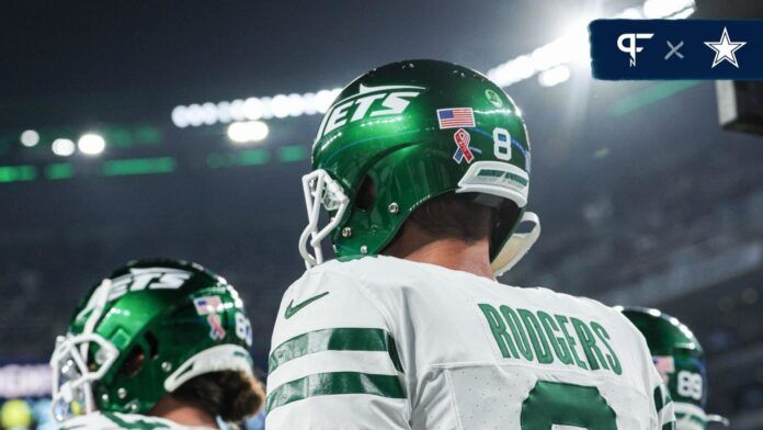 New York Jets quarterback Aaron Rodgers (8) walks on the field at MetLife Stadium before the game against the Buffalo Bills.