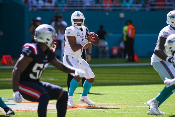 Miami Dolphins QB Tua Tagovailoa (1) looks to throw the ball deep against the New England Patriots.