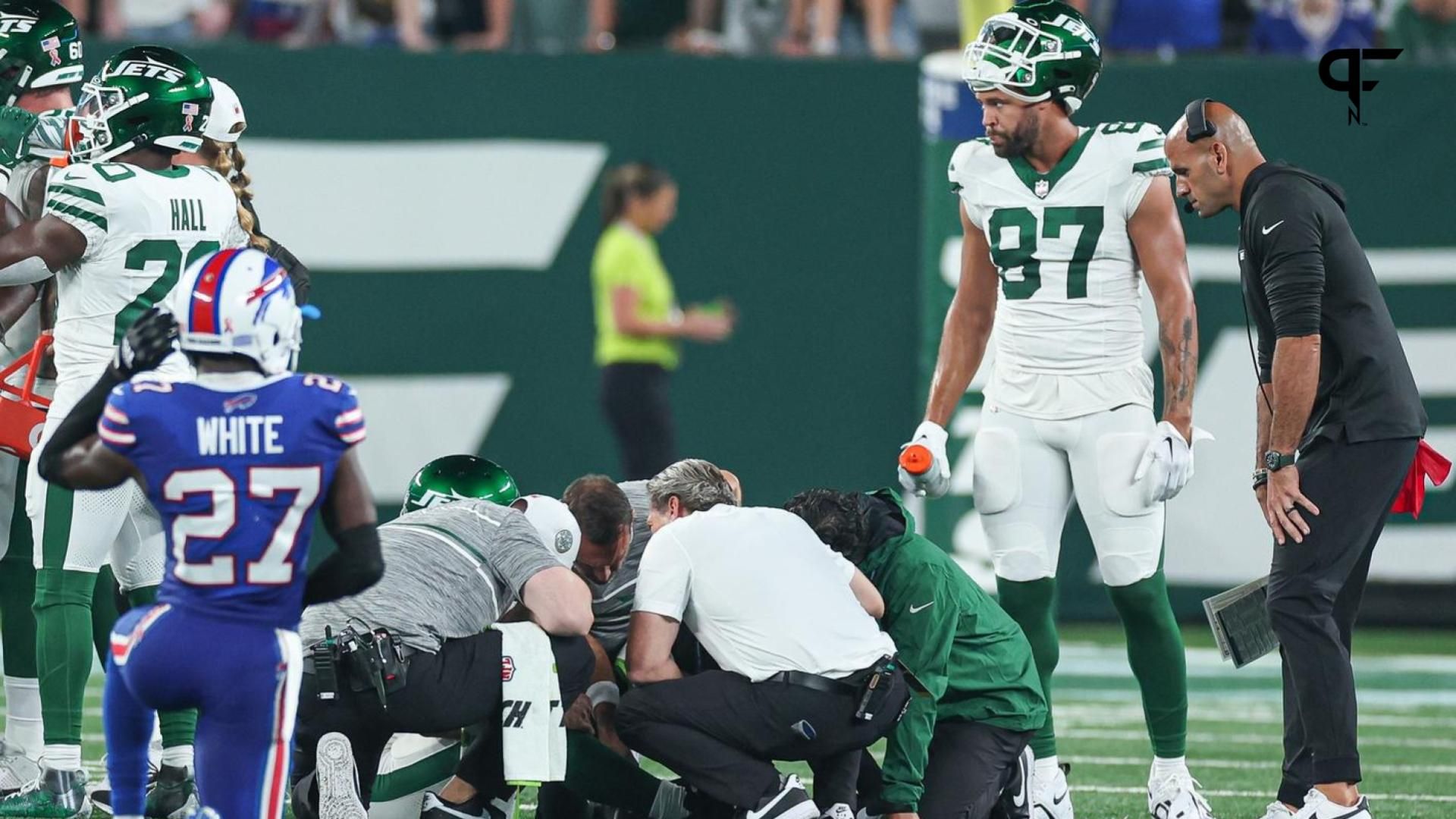 Medical staff tend to New York Jets quarterback Aaron Rodgers (8) after an injury in front of tight end C.J. Uzomah (87) and head coach Robert Saleh during the first half against the Buffalo Bills at MetLife Stadium.