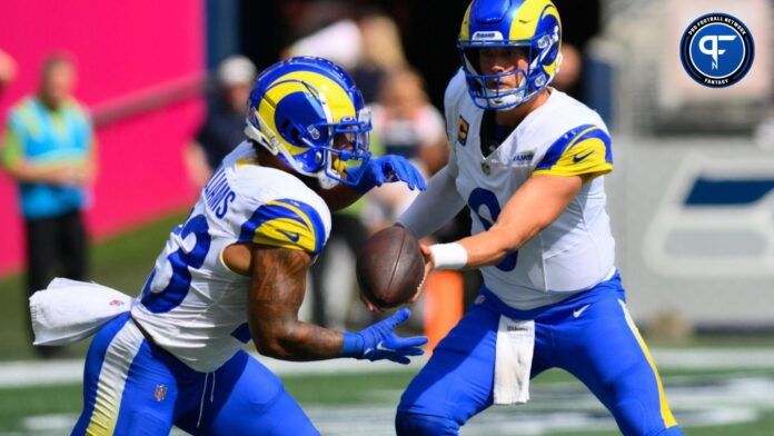 Los Angeles Rams quarterback Matthew Stafford (9) hands the ball off to running back Kyren Williams (23) during the first half against the Seattle Seahawks at Lumen Field.