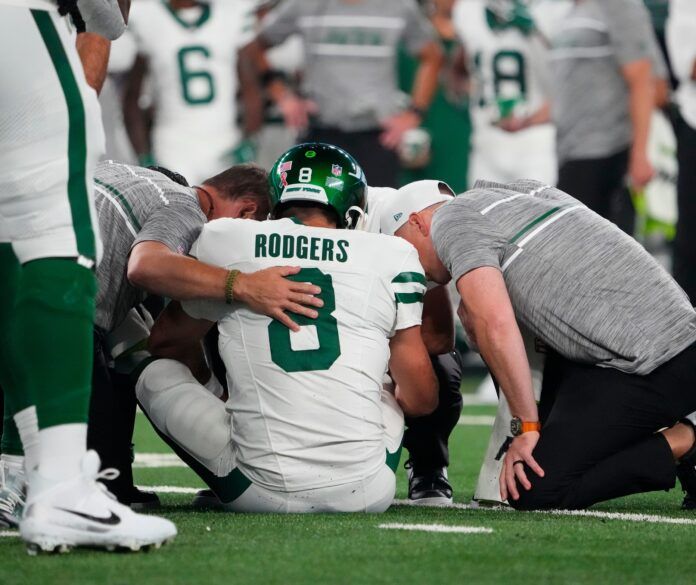 New York Jets quarterback Aaron Rodgers (8) is injured after a sack by Buffalo Bills defensive end Leonard Floyd (not pictured) during the first quarter at MetLife Stadium.