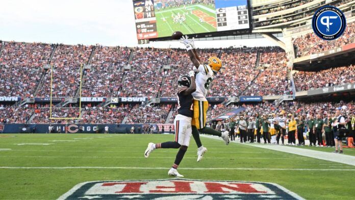 Green Bay Packers wide receiver Romeo Doubs (87) reaches over Chicago Bears defensive back Tyrique Stevenson (29) to catch a 4-yard touchdown pass in the second half at Soldier Field.